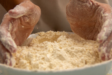 Woman piling flour with her hands