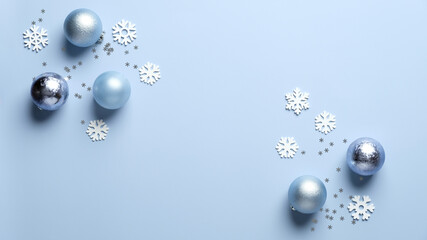 Modern Christmas composition. Shiny balls decoration and white snowflakes on blue background. Flat lay, top view. Christmas, New Year, winter holidays celebration concept.