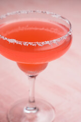 Red Margarita cocktail on a pink background