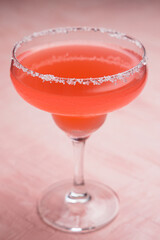 Red Margarita cocktail on a pink background