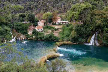 view on an beautiful village encircled by a turquoise river and wilderness