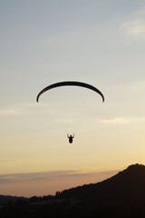 paraglider silhouette at sunset