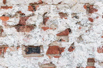 Old chipped white brick wall texture background, whitewashed
