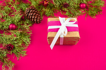 gift wrap on pink background with christmas decoration