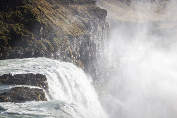 GULLFOSS, ICELAND, SEPTEMBER 19, 2018: Mist rising from famous waterfall located in the canyon of the Hvítá river in southwest Iceland. Sunny day during autumn.