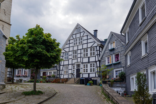 Outdoor street view of small town with traditional German wooden townhouses around Neviges Church in Velbert, Germany.