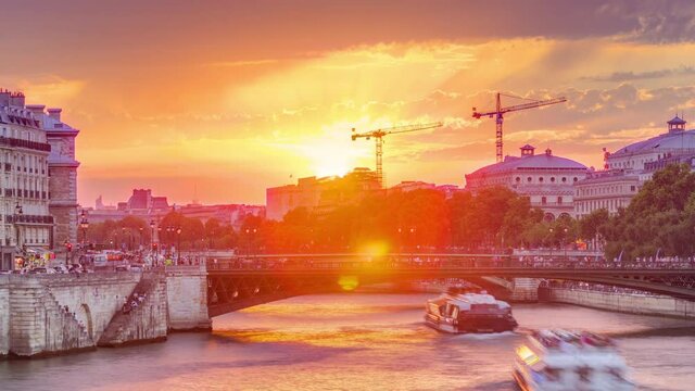 Le Pont D'Arcole bridge at sunset with people and boats timelapse, Paris, France, Europe. Colorful sky at summer day with reflection on river Seine