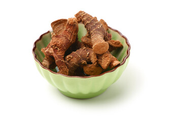 Dried galangal root isolated on white background