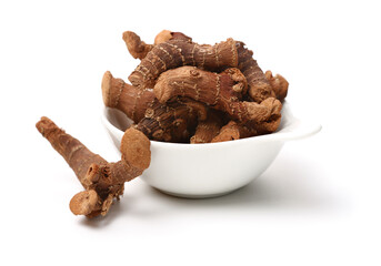 Dried galangal root isolated on white background