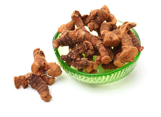 Dried galangal root isolated on white background