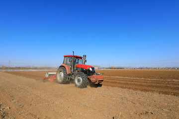 Fototapeta premium Planter planting peas on farm, North China