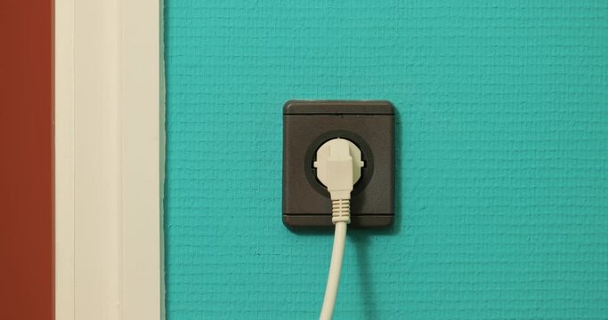 Electric outlet plugging and unplugging a power cord, European Type F