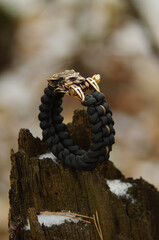 Handmade black braided paracord bracelet with brass lock lynx head totem