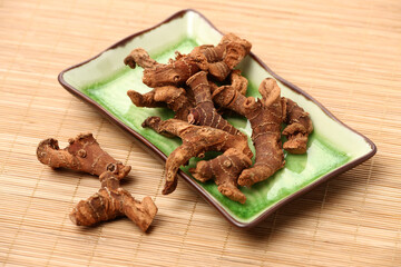 Dried galangal root isolated on white background