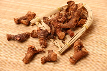 Dried galangal root isolated on white background
