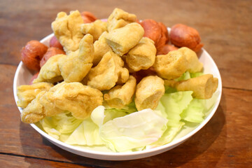 Delicious fried various meat ball, Mix asian seafood Appetizers dish isolated on brown wooden table