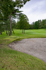 Fototapeta premium Golf Course with beautiful green field. Golf course with a rich green turf beautiful scenery.