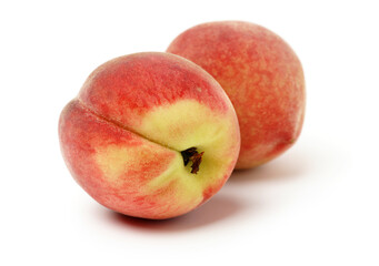 two red peaches on white background.