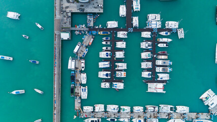 Aerial View Top down Drone shot of Yacht and sailboat parking in marina Transportation and travel background concept.