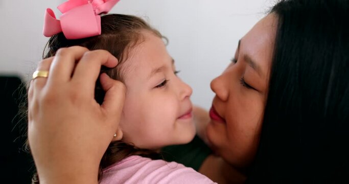 Cute little girl hugging and loving mom. Candid authentic affection and love between mother and child