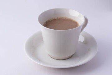 Coffee in a white mug on a white background. Copy space.