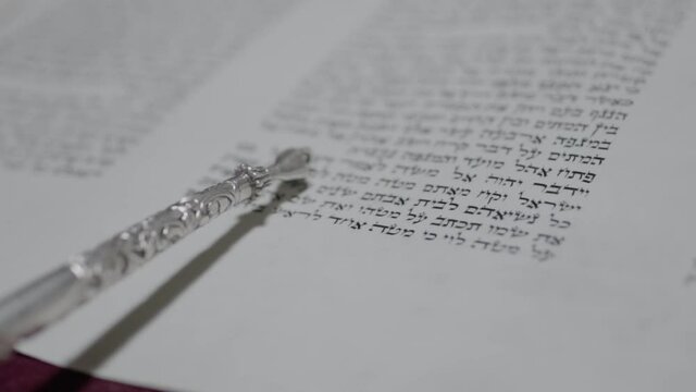 Reading a Torah scroll. Close-up slow motion