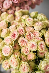 Flowers arrangement in pumpkin on wooden table. Fresh cut flowers for decoration home. European floral shop. Delivery fresh cut flower.