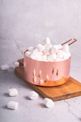 selective focus. small white marshmallows with a slide lie in a beautiful pink metal saucepan