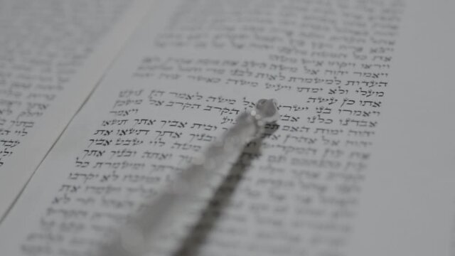 Reading a Torah scroll. Close-up slow motion