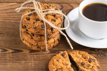 homemade cookies and a mug with coffee on a wooden background