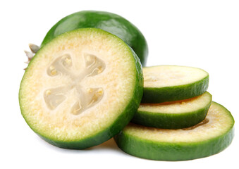 Whole feijoa and slices of sliced feijoa are isolated on a white background.