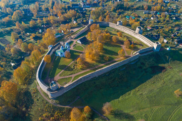 Above the ancient fortress of Izborsk is ggolden autumn. Pskov region, Russia