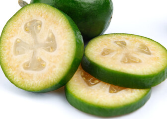 Whole feijoa and slices of sliced feijoa .