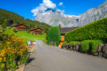 Fototapeta na wymiar Cozy street in the beautiful alpine village, Grindelwald, Switzerland