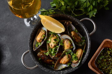 Classic French meal Moules marinière  Marinara mussels with garlic, sauce, lemon and parsley. 