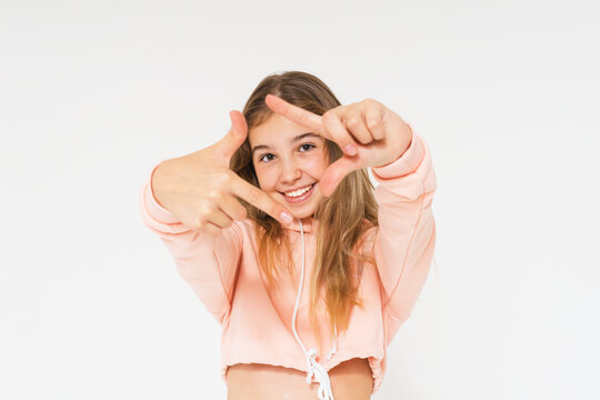 Cute smiling teenage girl with long hair in pink hoodie isolated on the white background