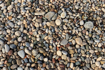 Smooth round pebbles texture background. Pebble sea beach close-up