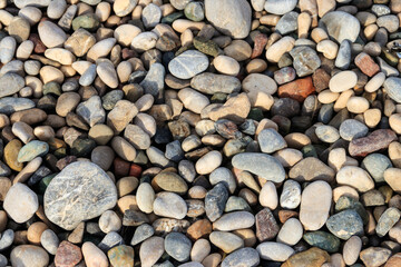 Smooth round pebbles texture background. Pebble sea beach close-up