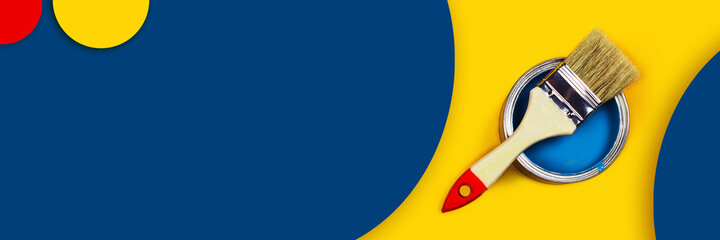 Abstract repair web-banner. One can of paint with a paintbrush on a yellow and classic blue background with colored circles made from paper.