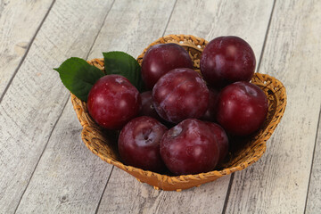 Plum heap in the wooden basket