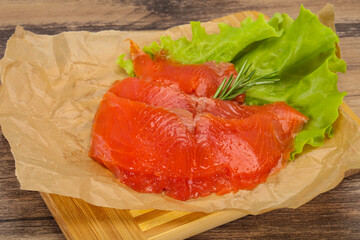 Sliced salmon fillet served rosemary