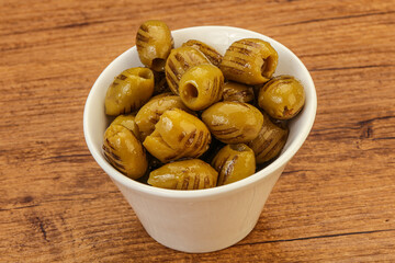 Green grilled olives in the bowl