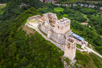 Csesznek, Hungary - Aerial view of the hilltop Castle of Csesznek and Csesznek city at sunset on a...