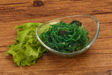 Green Chuka Seaweed Salad Isolated on White Background Top View. Wakame Sea Kelp Salat