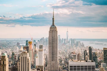 Foto op Plexiglas Empire State Building Close up view of the Empire State Building and the New York city skyline on a beautiful blue sky day