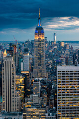 Close up view of the Empire State Building and New York City skyline on a beautiful evening with city lights