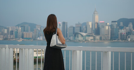 Fototapeta na wymiar Woman look at the city in Hong Kong