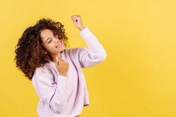 Young african american woman on yellow copy space background