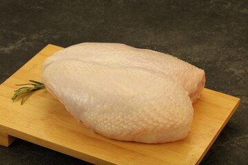 Raw whole chicken breast with skin