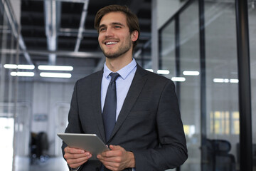 Young man using his tablet in the office.